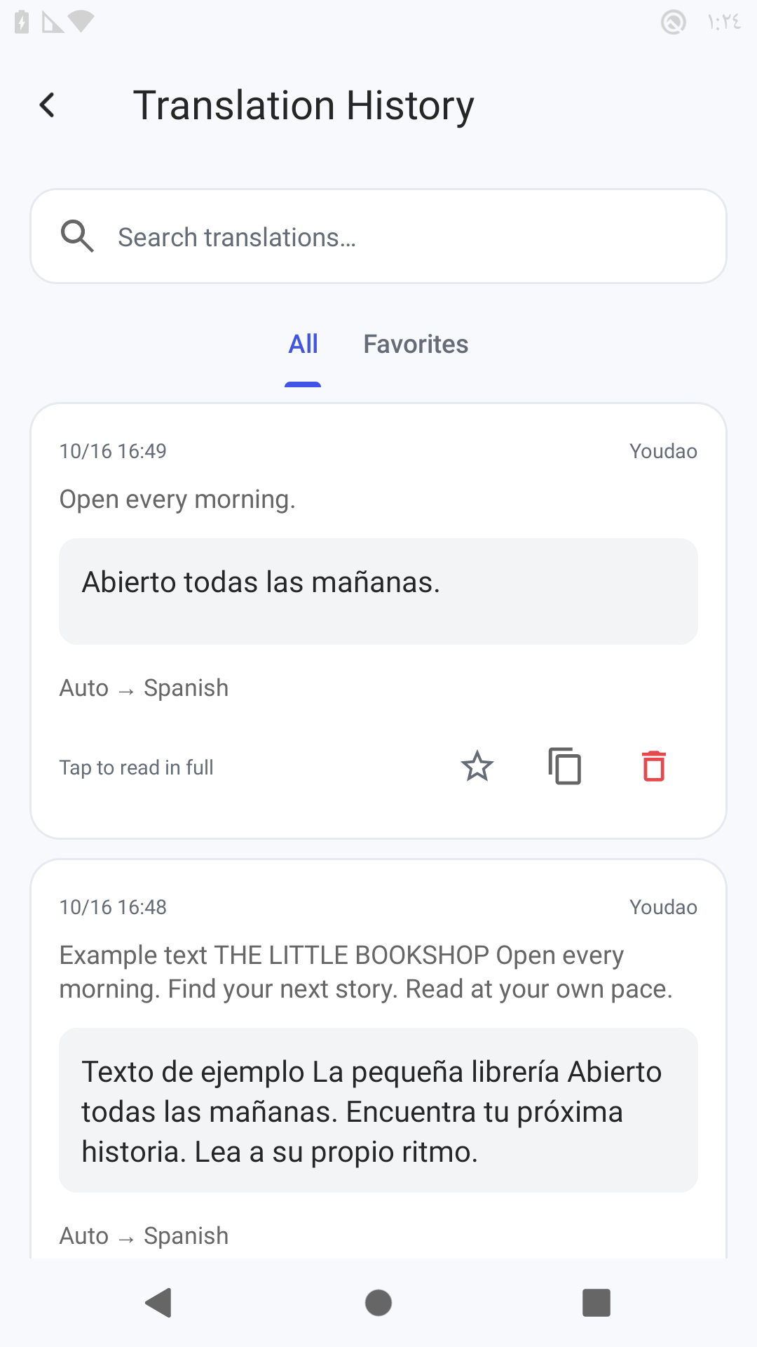 Translation History with two saved bookstore results showing English originals and Spanish translations